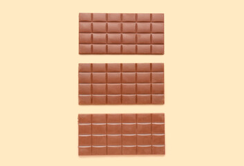 Tasty chocolate bars on color background