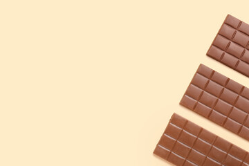 Tasty chocolate bars on color background