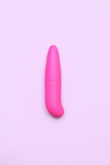 Pink vibrator from sex shop on lilac background