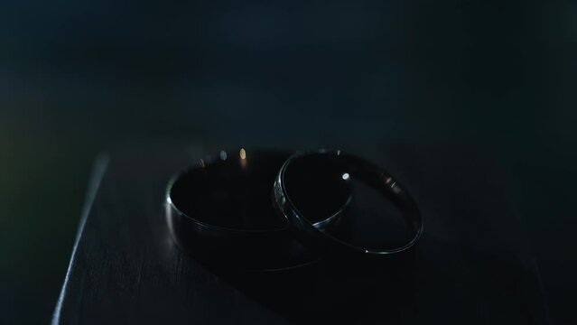 Shooting two gold rings lying on the table. Shooting with dynamic light