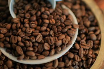 Roasted coffee beans in white cup. retro style toned, copy space. Background and texture of roasted coffee beans