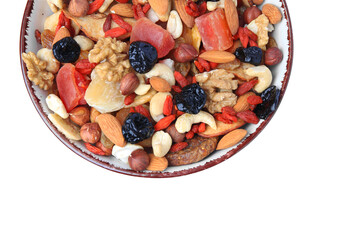Bowl with mixed dried fruits and nuts isolated on white, top view