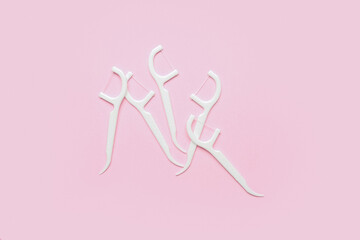 Floss toothpicks on pink background