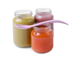 Glass jars with healthy baby food and spoon isolated on white