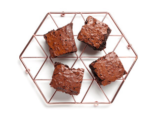 Grid with pieces of tasty chocolate brownie isolated on white background
