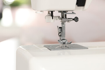 Modern sewing machine in atelier, closeup view