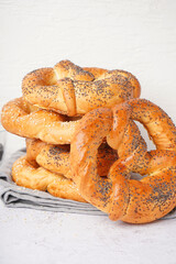 Stack of tasty pretzels on light background, closeup