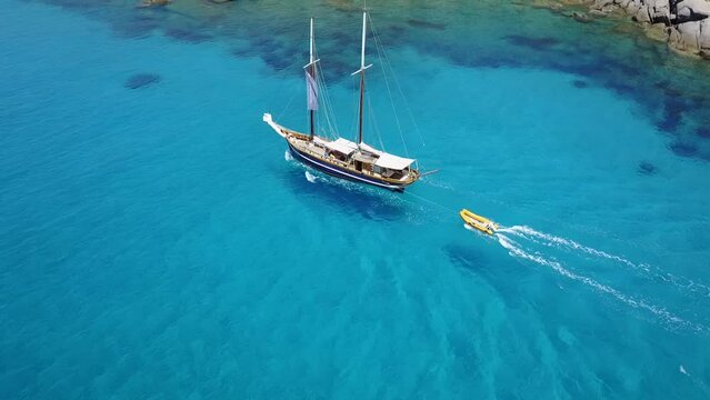 Travel, aerial and boat in ocean for cruise, holiday and summer vacation on islands in Mauritius. Sailing transport, sea landscape and top view of yacht for tropical adventure, freedom and traveling