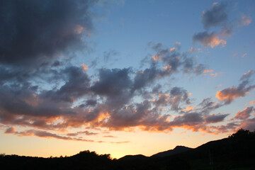 cloud and vanilla sky background with dark mountain silhouette