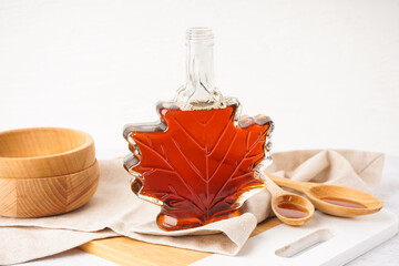 Bottle tasty maple syrup on white table