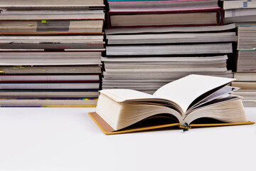 There is a book in front of several books. a pile of books. a bundle of books. books