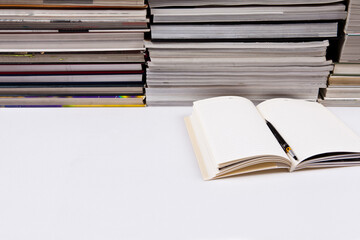 There is a book in front of several books. a pile of books. a bundle of books. books