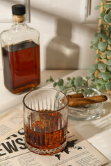 Glass of cold rum on table