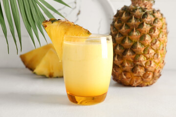 Fototapeta na wymiar Glass of tasty pineapple smoothie on table