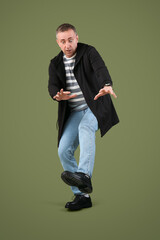 Scared mature man on green background