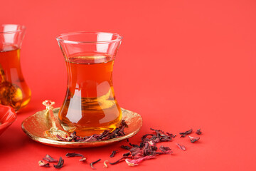 Glass of Turkish tea on red background