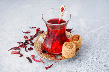 Glass of hibiscus tea and Turkish delight on light background