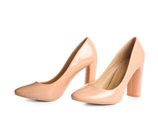 Pair of beige high heeled shoes on white background