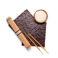 Bamboo mat, natural nori sheets, chopsticks and bowl of rice isolated on white background