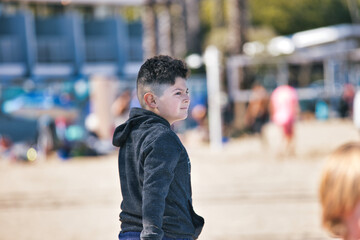 a boy playing on the beach in Venice Beach, CA