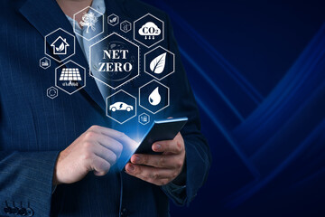 Businessman using digital device to get information about Net zero. Net zero emission, Clean technology, Renewable energy concept.