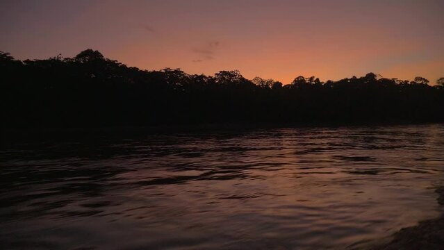 sunset in a tropical forest from a boat in the Amazon, Peru