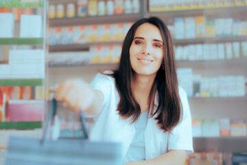 Pharmacy Saleswoman Giving a Shopping Bag to a Customer. Friendly pharmacy worker offering the buyer his purchase 
