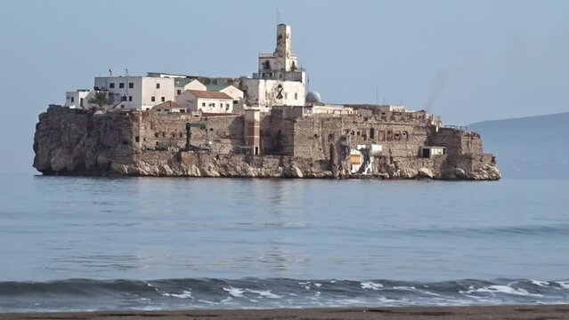 Waves crashing in a moroccan beach in front of the Alhucemas island, which is a spanish territory a few meters away.