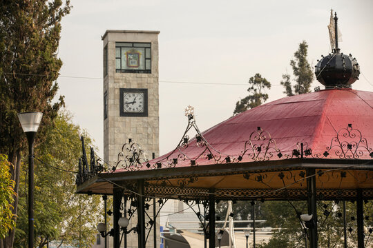Ecatepec de Morelos, Mexico - November 19, 2022: Morning light shines on the central kiosk and public clock tower.