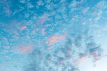 Fototapeta na wymiar Image of a blue sky with rare clouds on the background of sunset or dawn.