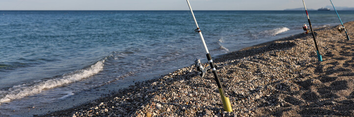 Fishing rod by sea and relaxing holiday