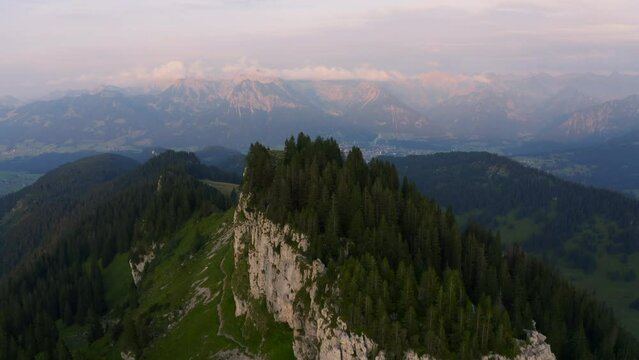 Aerial view rising over the Riedberger Horn peak, dusk in Allgau, Bavaria, Germany