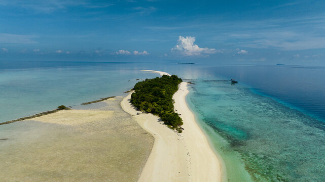 Aerial view of sandy tropical island with a beautiful beach surrounded by a coral reef.Timba Timba islet. Tun Sakaran Marine Park. Borneo, Sabah, Malaysia.