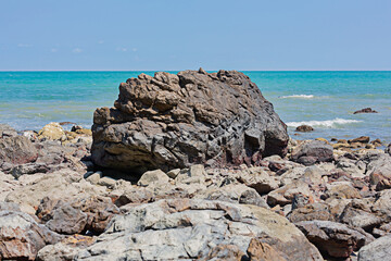 Rocks lost beach in the summer sea of Thailand.