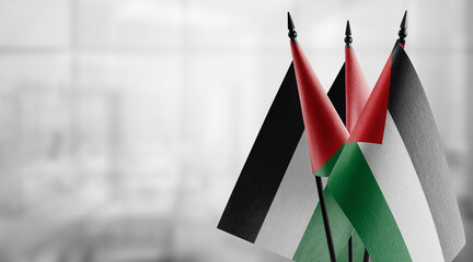 Small flags of the Palestine on an abstract blurry background