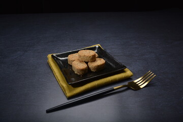 homemade Japanese western asian cookies with peanut, matcha, earl grey tea, almond green tea and icing sugar in round shape on black and gold luxury background handmade fresh bakery pastry halal menu