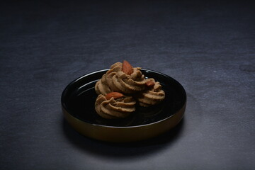homemade halal quqi cookies with peanut, matcha, earl grey tea, almond green tea and icing sugar in round shape on black and gold luxury background handmade fresh bakery pastry halal menu