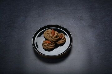 homemade halal quqi cookies with peanut, matcha, earl grey tea, almond green tea and icing sugar in round shape on black and gold luxury background handmade fresh bakery pastry halal menu