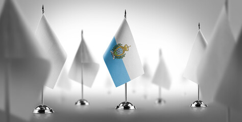 The national flag of the San Marino surrounded by white flags