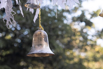 Closeup view of beautiful old fashioned golden christmas bell hanging as new year toys, horizontal picture