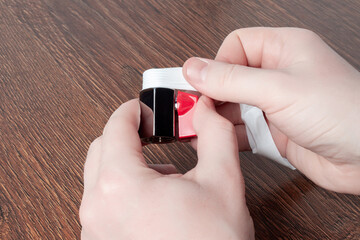 Man using teflon tape to seal water ball faucet with red valve. Wrap PTFE tape on valve thread....