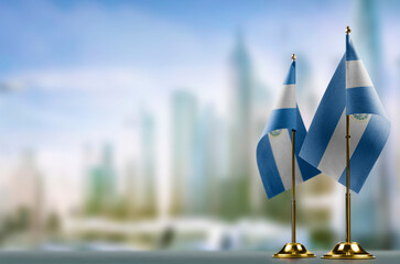 Small flags of the Salvador on an abstract blurry background