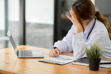 Asian female doctor Tired of working, exhausted, sleepy at the clinic or hospital