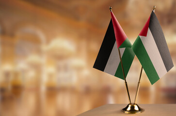 Small flags of the Palestine on an abstract blurry background