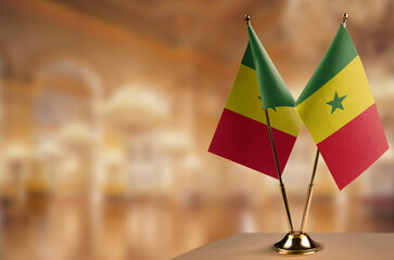 Small flags of the Senegal on an abstract blurry background