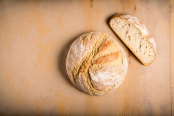 bread on wooden background, freshly baked bread sliced into slices, freshly baked bread on a wooden table