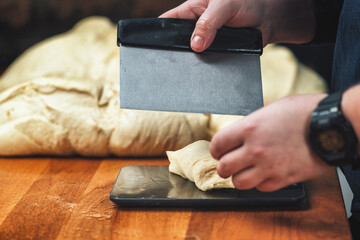 Baker cutting and weighing dough