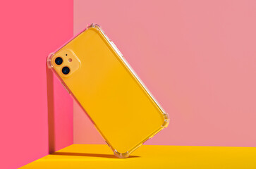 Yellow iPhone 11 and 14 Plus in clear phone case, bright and colorful phone case mock up 