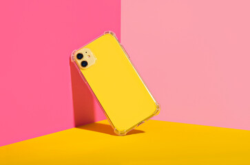 Yellow iPhone 11 and 14 Plus in clear phone case, bright and colorful phone case mock up 