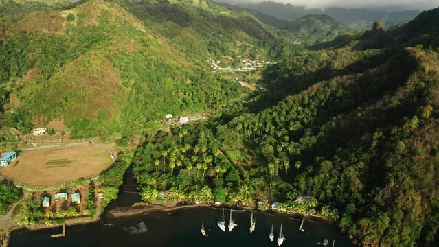 Arial drone shot of mountains of Saint Vincent by the caribbean see.